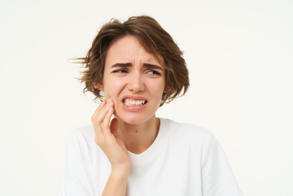 close-up-woman-has-tooth-decay-touching-cheek (Medium) close-up-woman-has-tooth-decay-touching-cheek (Medium)