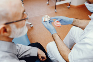dentist showing partial denture