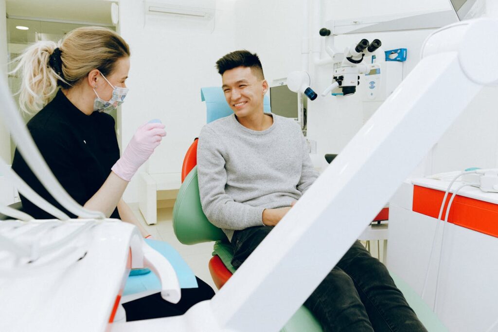 happy patient smiling at dentist happy patient smiling at dentist