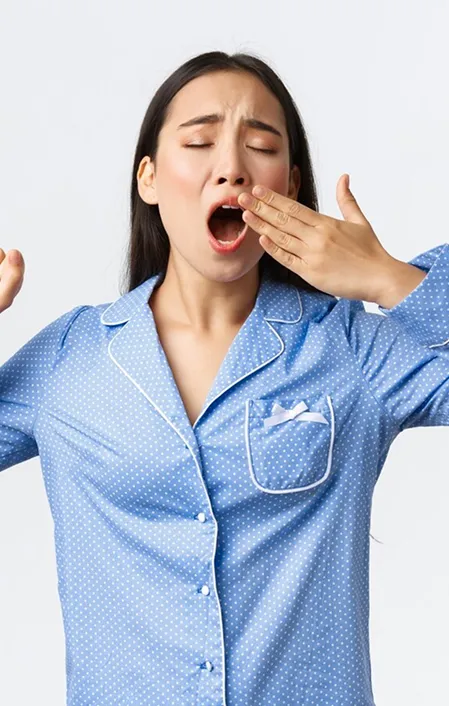 asian woman yawning due to poor sleep