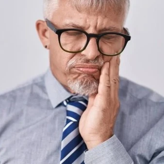 Man Holding Side Of Face With Tooth Abscess Thumbnail
