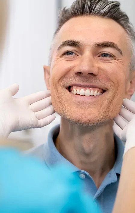 smiling older man with tooth dental bridge