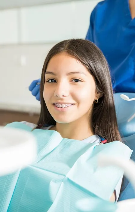 young girl with braces needs fissure sealants