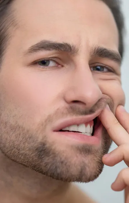 man looking worriedly at teeth gum problems