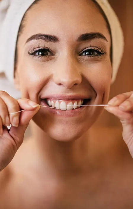 woman happy smiling flossing teeth cleaning