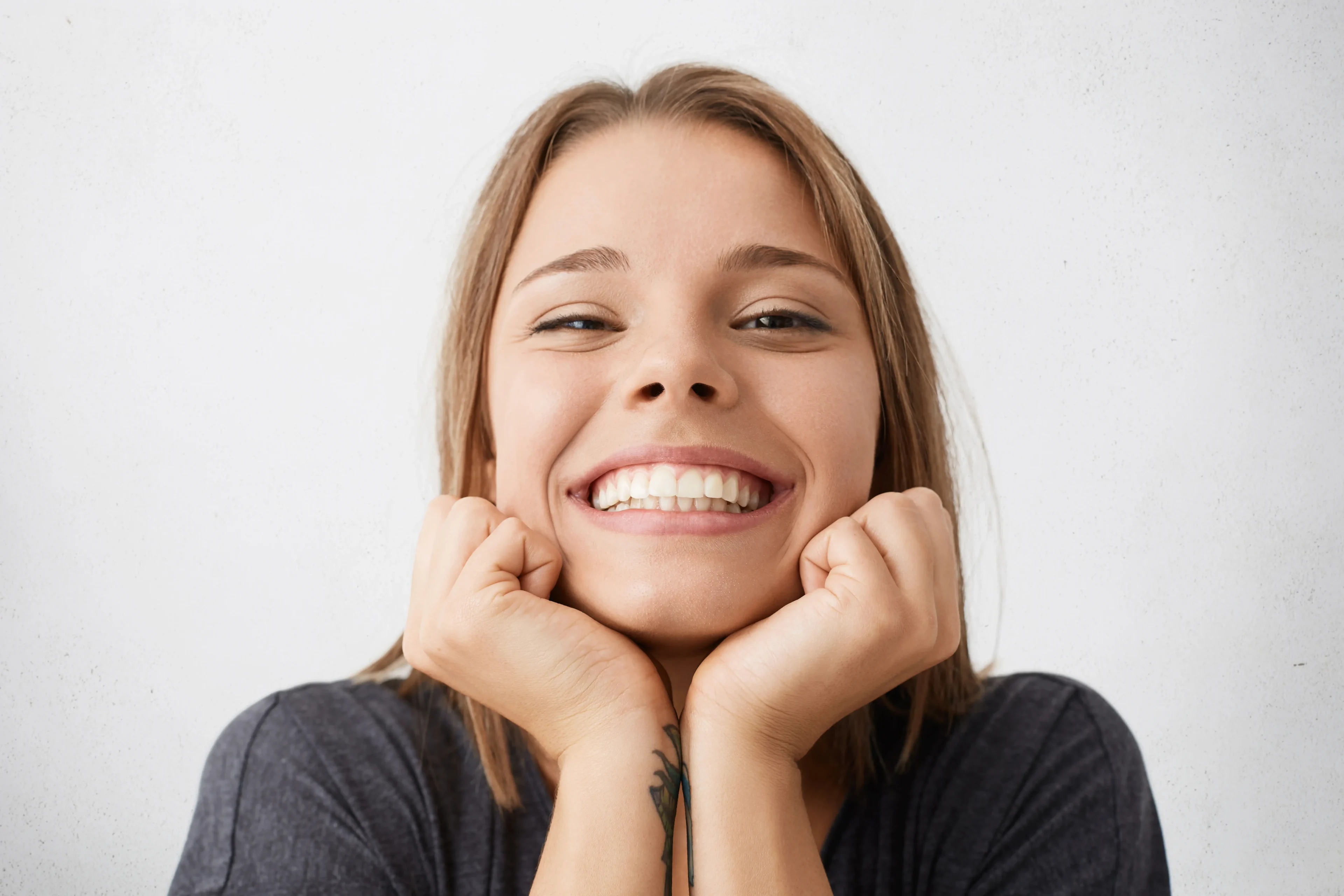 Close Up Indoor Portrait Happy Excited Young Female Celebrating Success Promotion Work Looking With Broad Cheerful Smile Holding Hands Her Face Feeling Joy Happiness