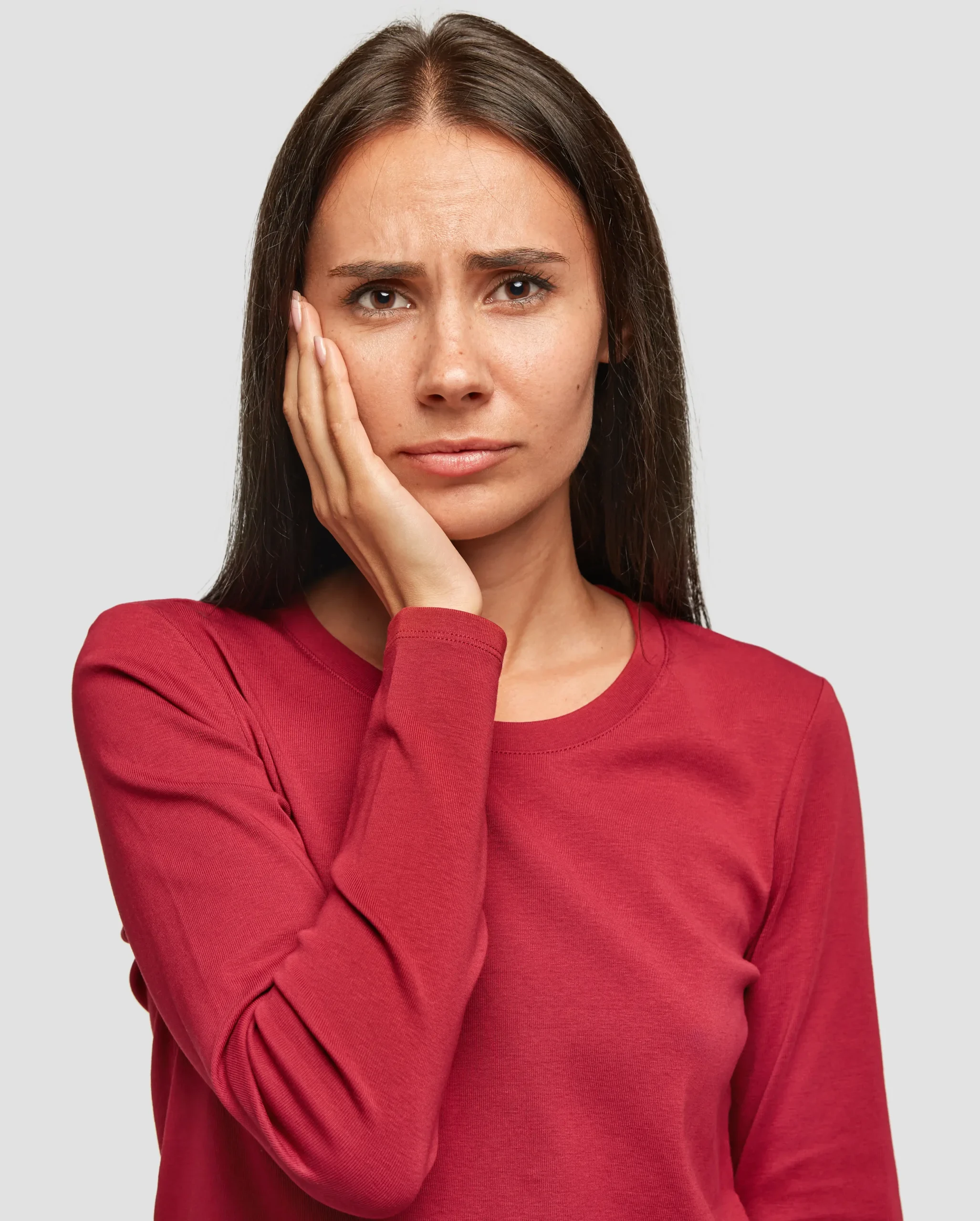 Indoor Shot Sad Unhappy European Woman With Unhappy Expression Keeps Palm Cheek Wears Casual Red Sweatshirt