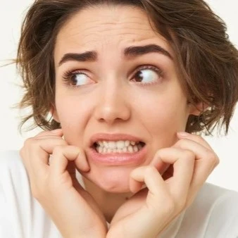 Woman Looking Worried Grinding Teeth Thumbnail