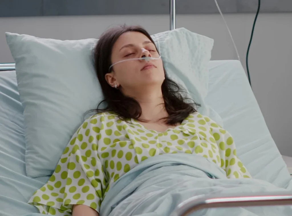 Woman Sleeping In Hospital Bed Before General Anesthetic Cropped